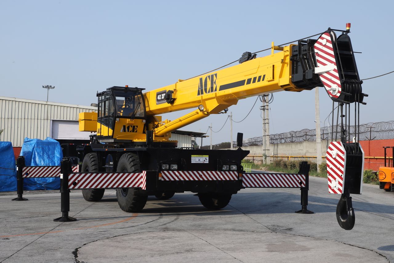 our-story A 40 ton ACE rough terrain crane parked outdoors in an industrial yard in Faridabad, India.